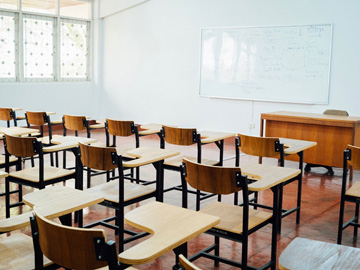 Disinfecting desks and other surfaces in a school