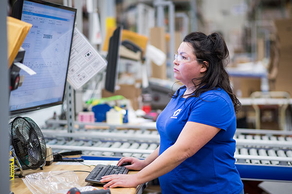 woman in warehouse computer 