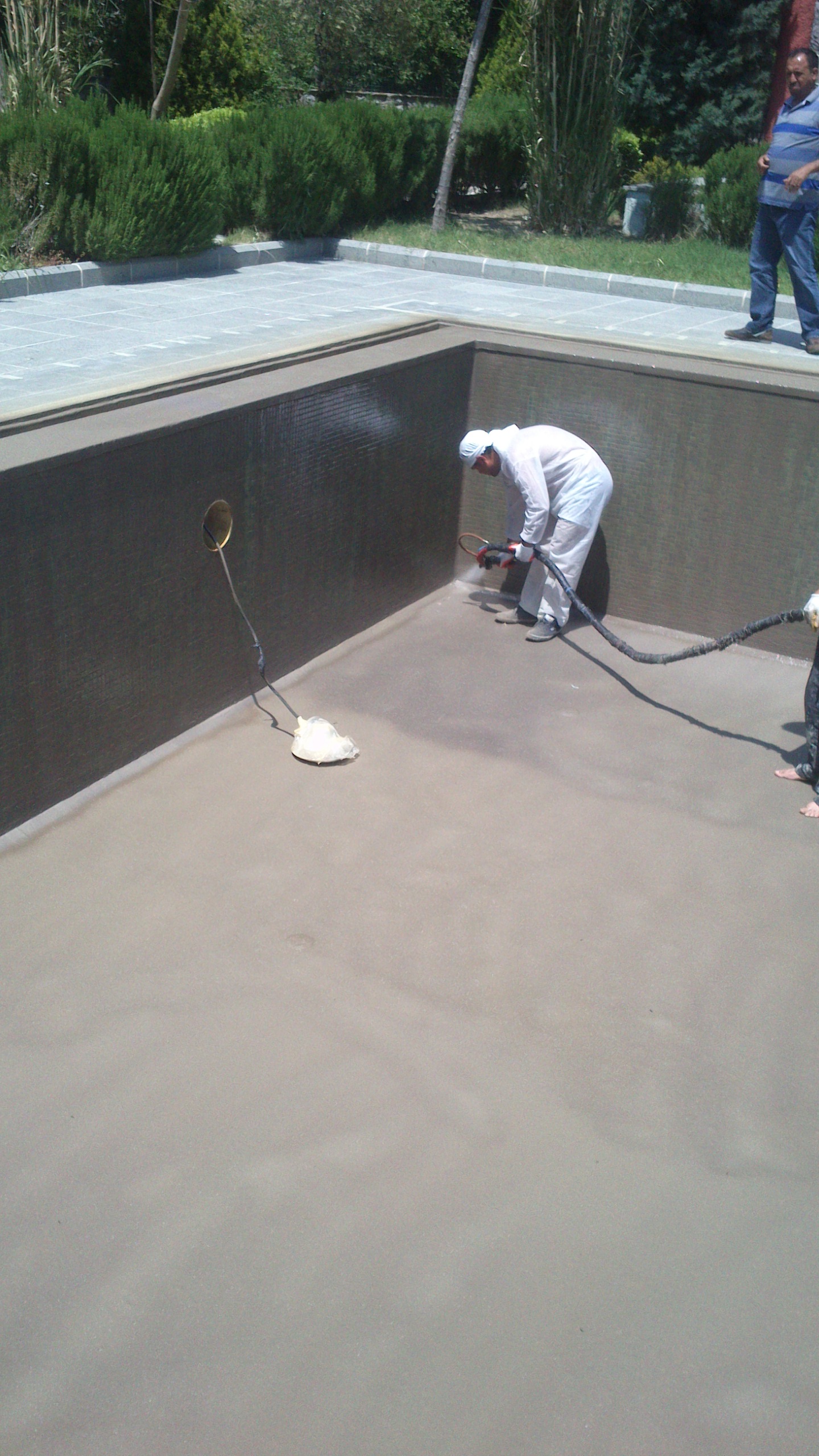 swimming pool being lined with polyurea-based coating