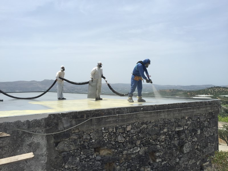 Spraying polyurea coating on a roof