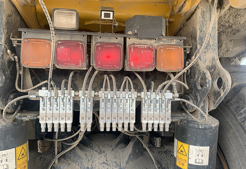 Graco GL-1 grease injectors for an automatic lubrication system installed on a Komatsu HD 465 haul truck