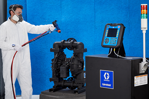 A paint booth operator uses electrostatics to spray waterborne material.