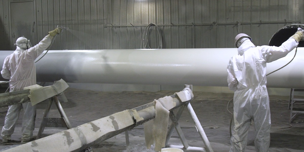 Two sprayers applying protective coatings