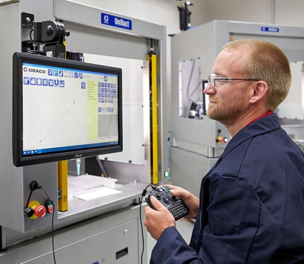 Man operating Unixact automated adhesive dispenser