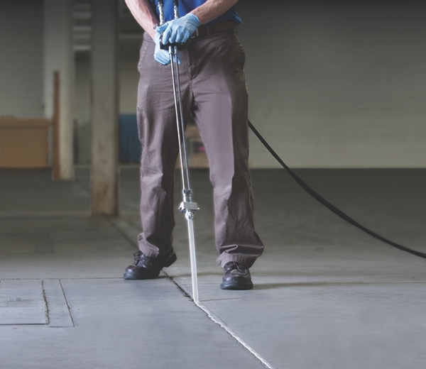 Flooring contractor filling joint in concrete floor