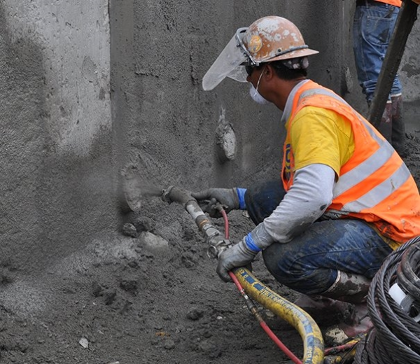 Contractor using a Graco mortar sprayer