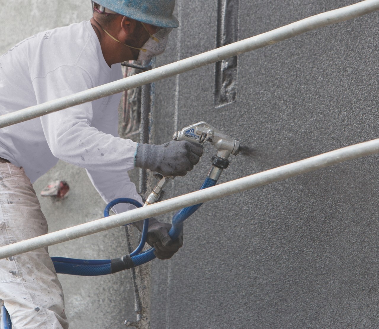 Applying stucco using a stucco sprayer