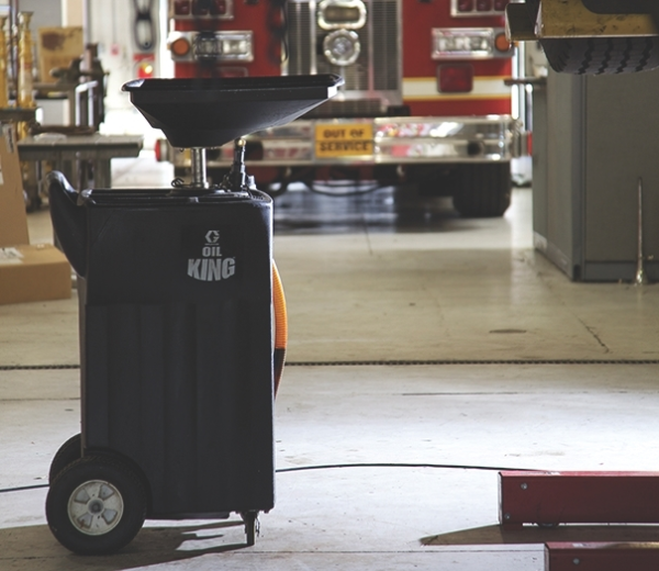 Oil King under hoist in a service garage