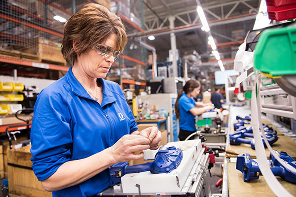 woman assembly line handheld sprayer